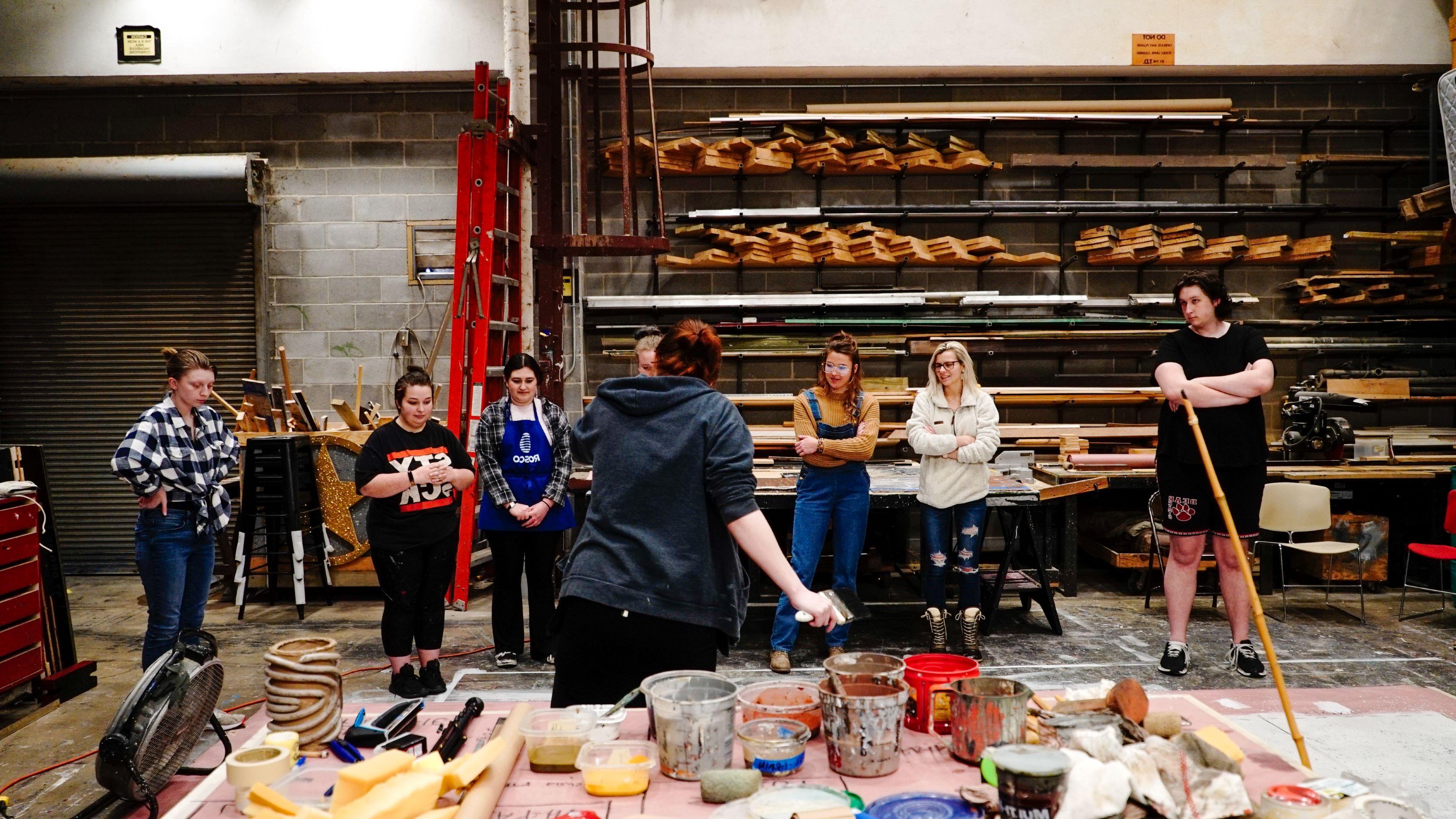 Students in a scenic painting workshop