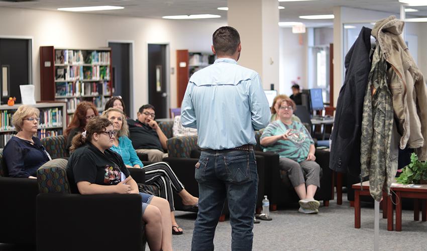 Tyler Froberg standing in front of the audience giving his presentation.