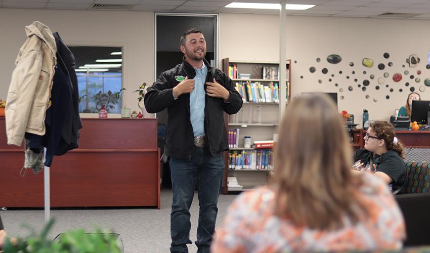 Tyler Froberg standing in front of the audience giving his presentation.