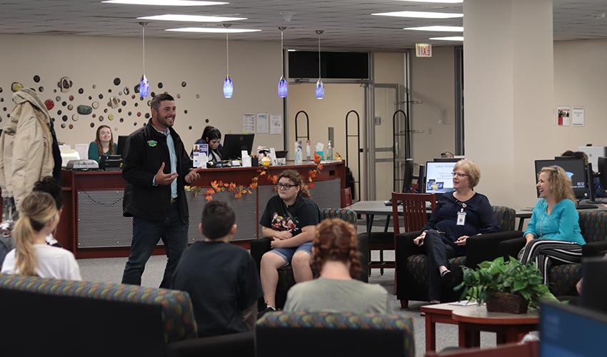 Tyler Froberg standing in front of the audience giving his presentation.