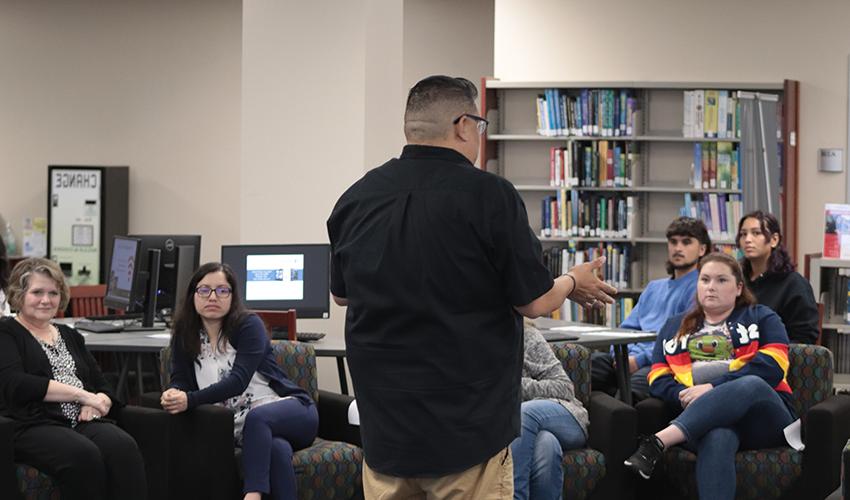 Joe Perez standing in front of the audience giving his presentation. 
