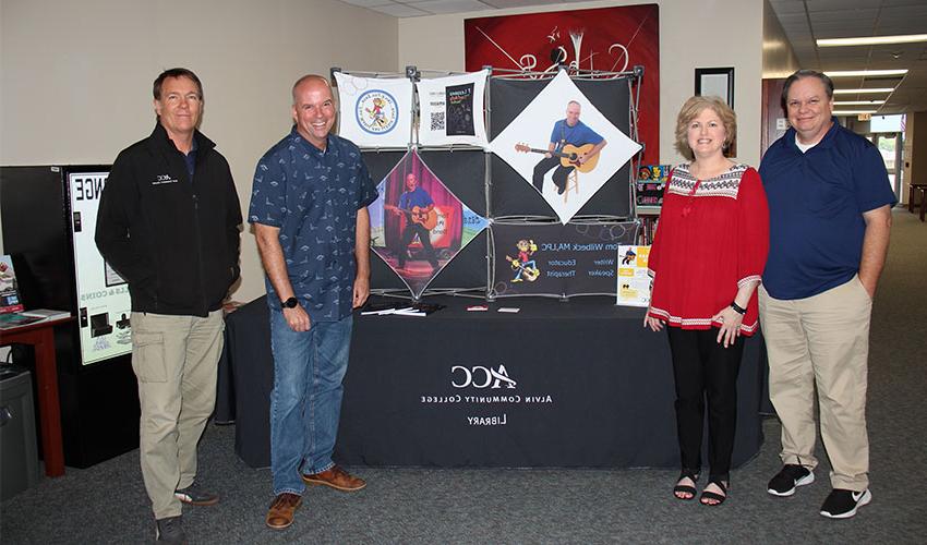 Picture of Tom Wilbeck with the library staff.